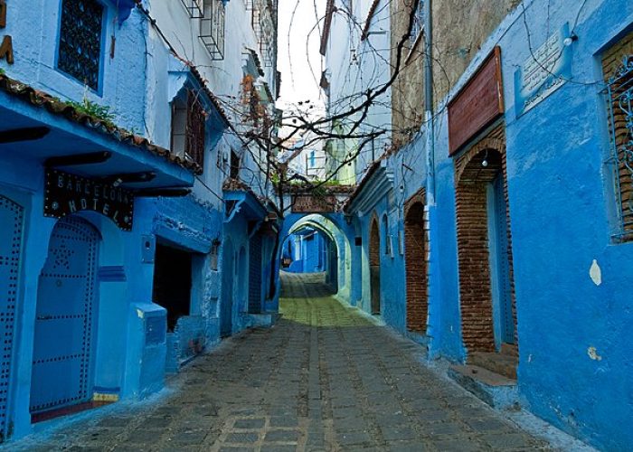 A view of one of the many blue-painted streets in Chefchaouen, Morocco...Chefchaouen is situated in the Rif Mountains, just inland from Tangier. The city was founded in 1471 as a small fortress by Moorish exiles from Spain led by Moulay Ali Ben Moussa Ben Rached El Alami to fight the Portuguese invasions of northern Morocco. It was known as one of the main concentrations of Moriscos (converted Christian inhabitants of Spain and Portugal of Muslim heritage) and Jews who sought refuge in this mountainous city after the Spanish Reconquista in medieval times.  In 1920, the Spanish seized Chefchaouen to form part of Spanish Morocco and returned the city after the independence of Morocco in 1956.