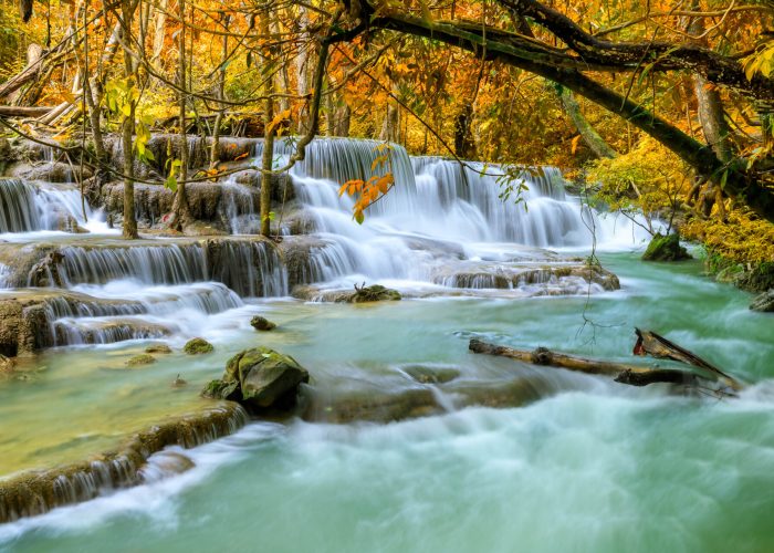 Colorful majestic waterfall in national park forest during autumn - Image